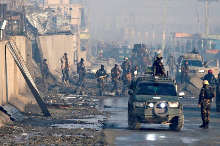 FILE PHOTO: Afghan security forces inspect the site of a car bomb blast at green village in Kabul, Afghanistan