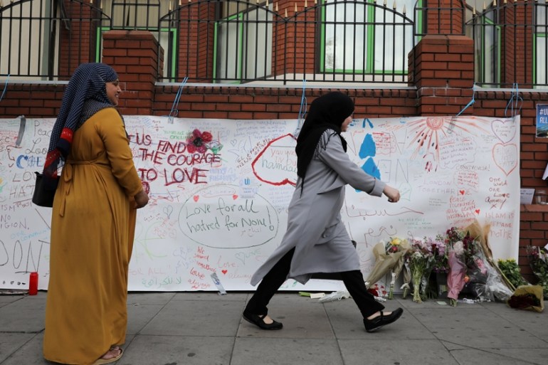 A woman walks past messages attached to a wall near the scene of an attack next to Finsbury Park Mosque, in north London Britain June 20, 2017. REUTERS/Marko Djurica