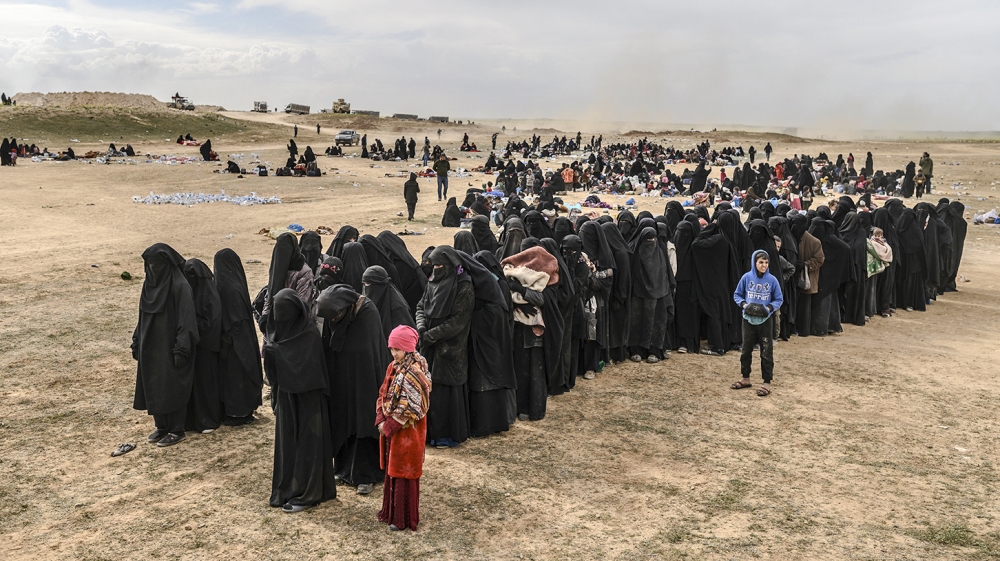 The families of ISIL fighters are believed to be among the latest civilians to flee [Bulent Kilic/AFP]