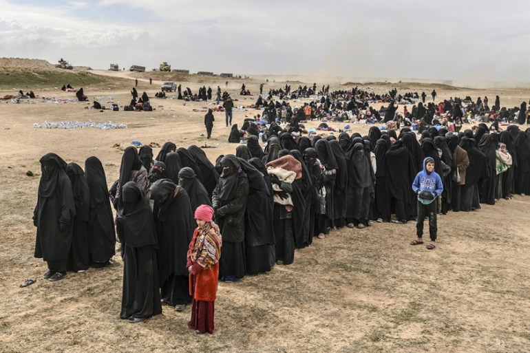 Civilians evacuated from the Islamic State (IS) group''s embattled holdout of Baghouz wait at a screening area held by the US-backed Kurdish-led Syrian Democratic Forces (SDF), in the eastern Syrian pr