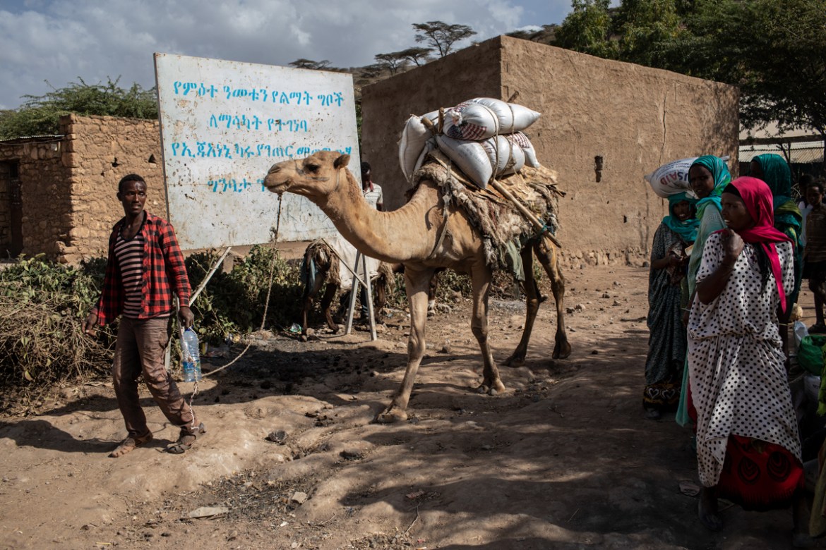 A man uses a camel to transport rations of wheat to his village from a distribution point in Ejianeni, in rural Dire Dawa administration, Ethiopia, on February 10, 2019.