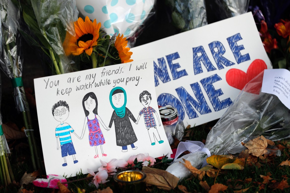A message card is placed at a collection of flowers left at the Botanical Gardens in Christchurch, New Zealand, Saturday, March 16, 2019. New Zealand''s stricken residents reached out to Muslims in the