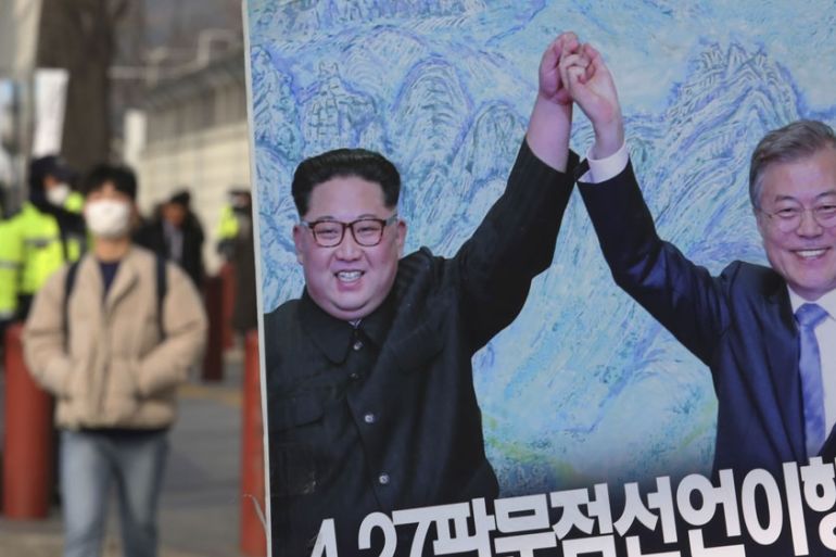 A banner showing a photo of North Korean leader Kim Jong Un and South Korean President Moon Jae-in, right, is displayed to wish for peace on the Korean