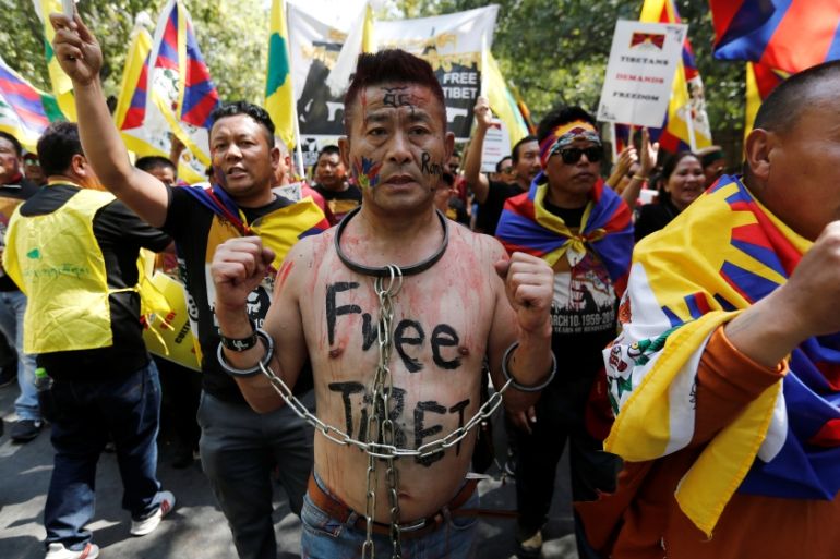 A Tibetan chains himself during a protest held to mark the 60th anniversary of the Tibetan uprising against Chinese rule, in New Delhi