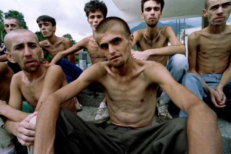 Emaciated Muslim refugees, recently released from a Croat prison in Dretelj, wait for lunch in a grammar school in Jablanica, central Bosnia, September 10, 1993. REUTERS/Yannis Behrakis/File photo SEA