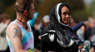 A woman wearing a headscarf as tribute to the victims of the mosque attacks [Reuters]