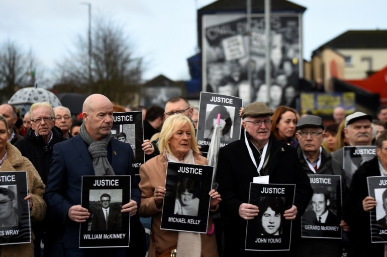 Families of the victims walk through the Bogside before the announcement of the decision whether to charge soldiers involved in the Bloody Sunday events, in Londonderry