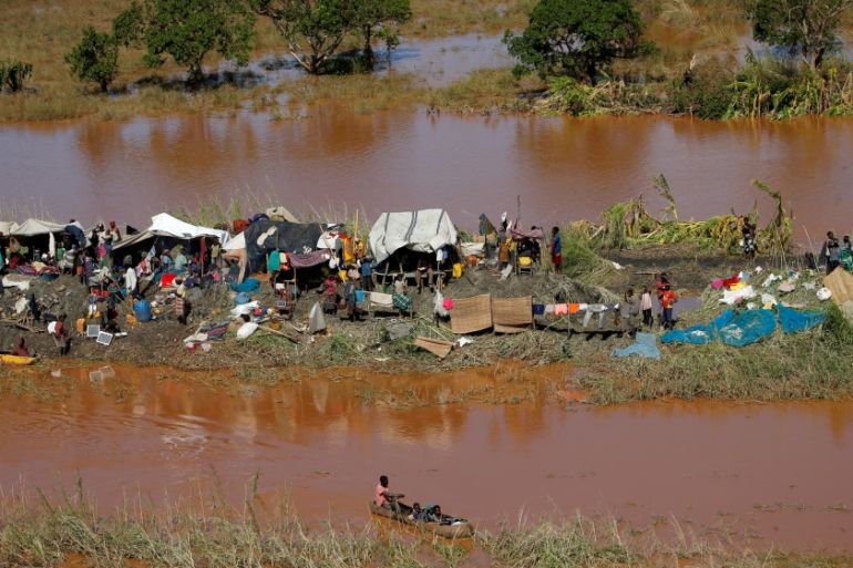 Stranded locals look on during floods after Cyclone Idai, in Buzi district, outside Beira
