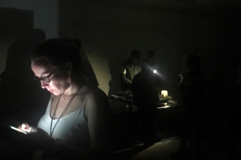 Passengers are seen during a blackout at Simon Bolivar international airport in Caracas