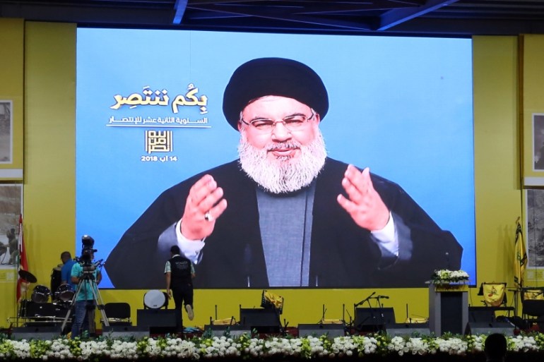 Lebanon''s Hezbollah leader Sayyed Hassan Nasrallah gestures as he addresses his supporters via a screen in Beirut