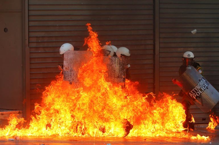 A group of riot policemen is engulfed in flames after protesters threw petrol bombs in Athens'' Syntagma square during a 24-hour labour strike September 26, 2012. Greek police fired teargas at hooded y