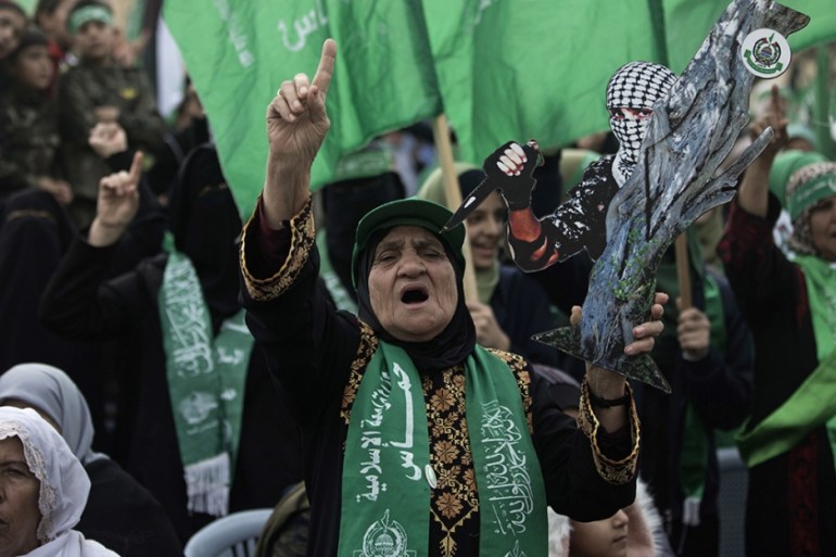 Women chant Islamic slogans during a mass rally marking the 31st anniversary of the founding of Hamas, an Islamic political party, which has an armed wing of the same name, that currently rules in Gaz
