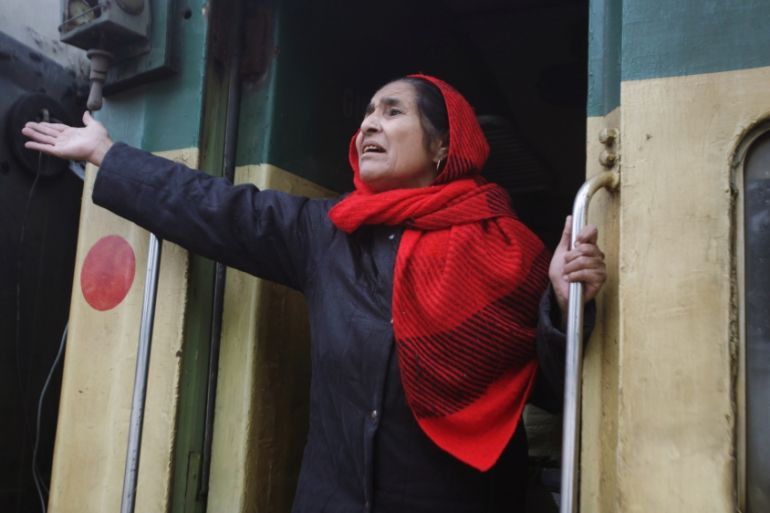 A passenger from India gestures to her relatives as she leaves by Samjhauta Express train which was temporarily suspended, at the railway station in Lahore,