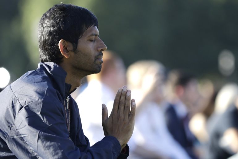 A man prays during a vigil in Hagley Park following the March 15 mass shooting in Christchurch, New Zealand, Sunday, March 24, 2019