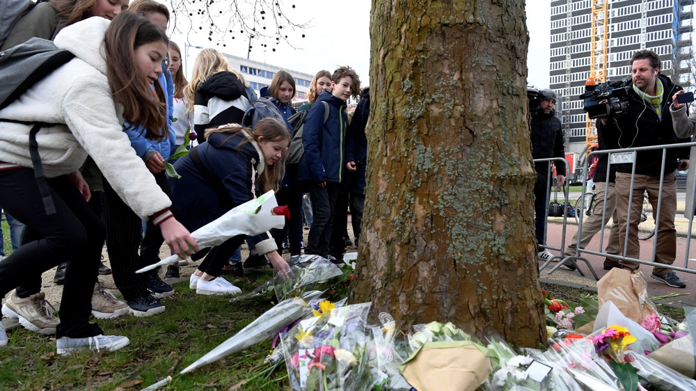Children placed flowers at the site of a shooting in Utrecht [Piroschka van de Wouw/Reuters]
