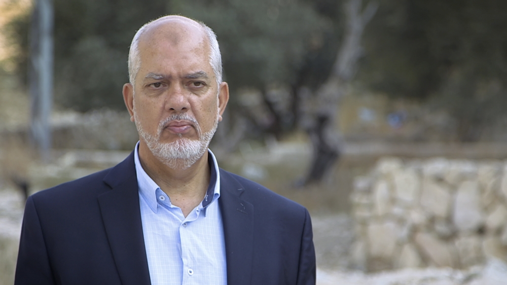 Mustafa Sway stands in the predominantly Palestinian neighbourhood of Silwan [Al Jazeera]
