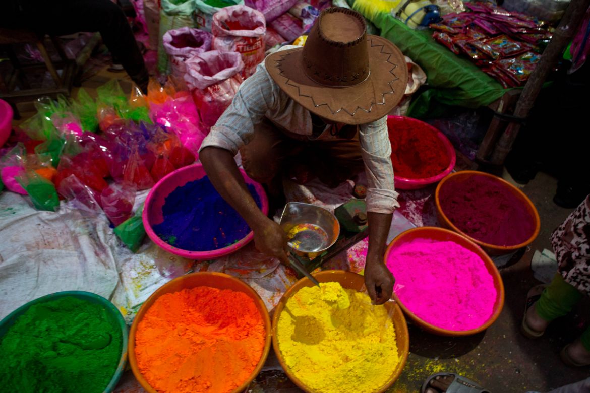 An Indian street vendor sells colored powder a day ahead of Holi, the festival of colors, in Gauhati, India, Wednesday, March 20, 2019. Holi also marks the advent of Spring season. (AP Photo/Anupam Na