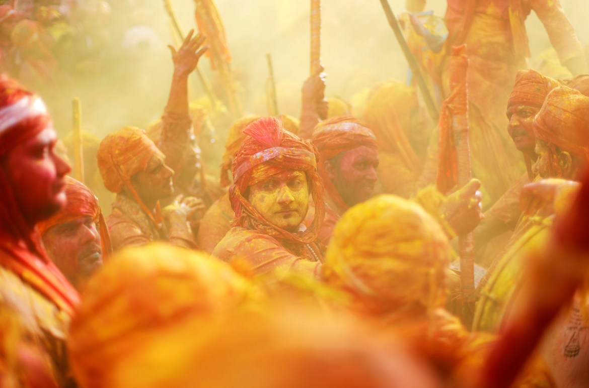 Hindu devotees take part in the religious festival of Holi inside a temple in Nandgaon village, in the state of Uttar Pradesh, India, March 16, 2019. REUTERS/Adnan Abidi - RC1417321B00