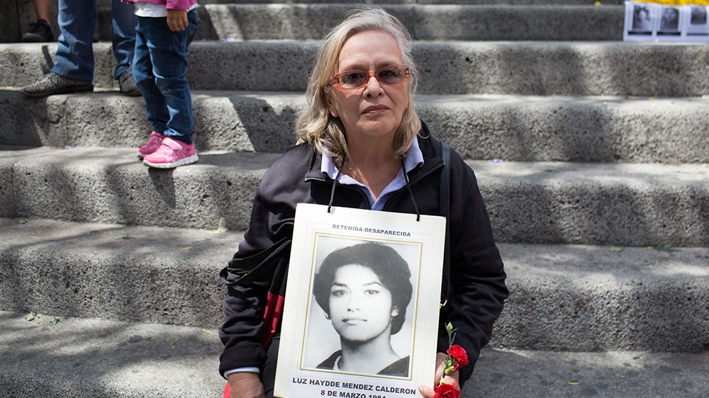 Mendez holds a photo of her sister, who disappeared on March 8, 1984 [Jeff Abbott/Al Jazeera]