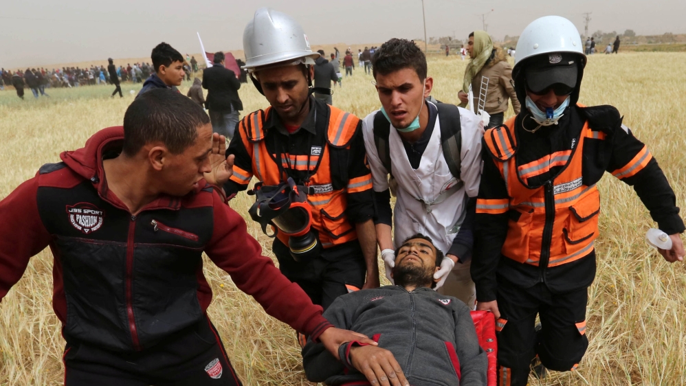 A wounded Palestinian is evacuated during the Great March of Return protests in the southern Gaza Strip [Ashraf Abu Amrah/ Reuters]