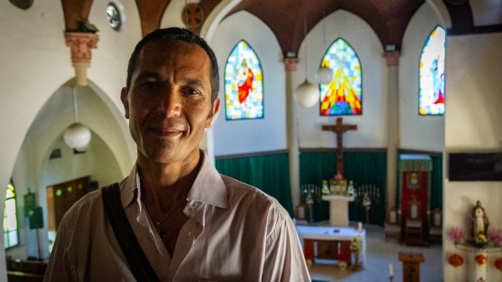 Refugee John Arash Sedigh, 40, at the church he attends in Makassar [Ian Morse/Al Jazeera] 