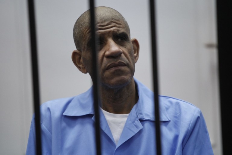 Abdullah al-Senussi , ex-spy chief in Muammar Gaddafi''s government, sits behind bars during a hearing at a courtroom in Tripoli