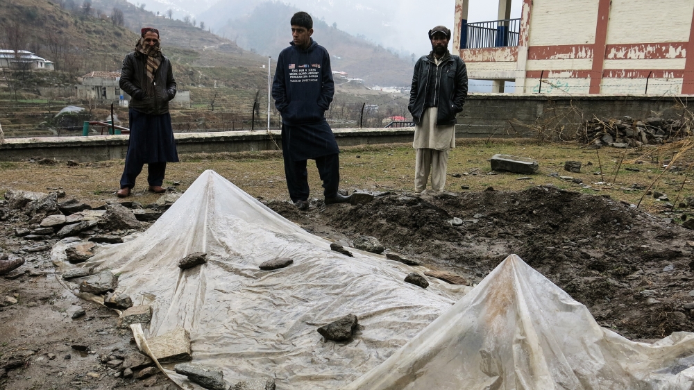 Afzal Kohistani's grave stands in the shadow of a government high school, a few metres away from the home he fled in the Allai Valley [Asad Hashim/Al Jazeera]