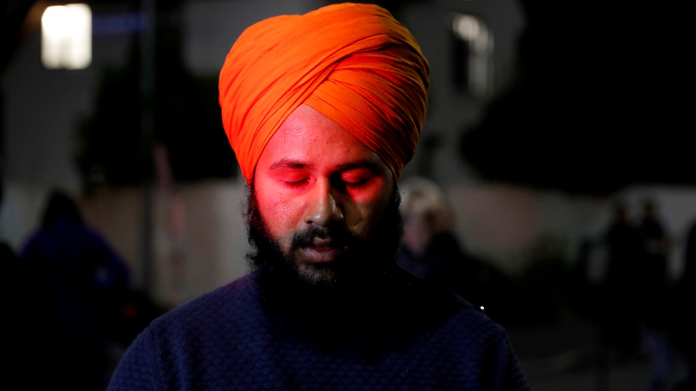 A Sikh man prays outside Masjid Al Noor in Christchurch [Jorge Silva/Reuters]