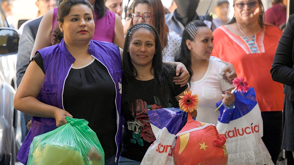 Alba Lorena Rodriguez (centre) and Cinthia Marcela Rodriguez (right) are pictured shortly after being released from the women's prison in Ilopango [Marvin Recinos/AFP] 
