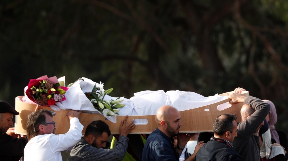 Many victims were carried to the grave alongside flowers, flags or personal mementos [Edgar Su/Reuters]