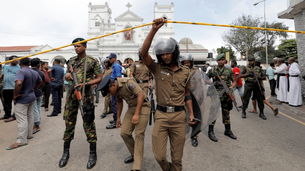 Sri Lankan military officials stand guard in front of St Anthony's Shrine [Dinuka Liyanawatte/ Reuters]