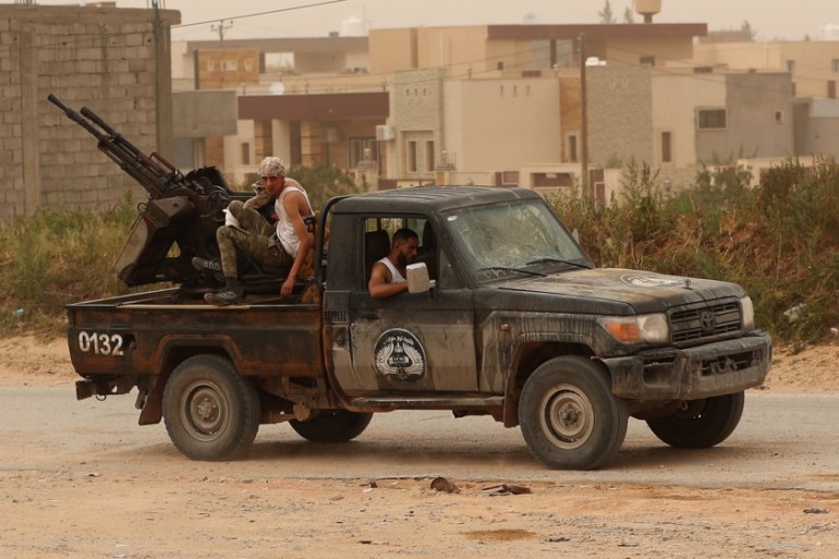 Members of the Libyan internationally recognised government forces take position during the fighting with the Eastern forces in Ain Zara, in Tripoli