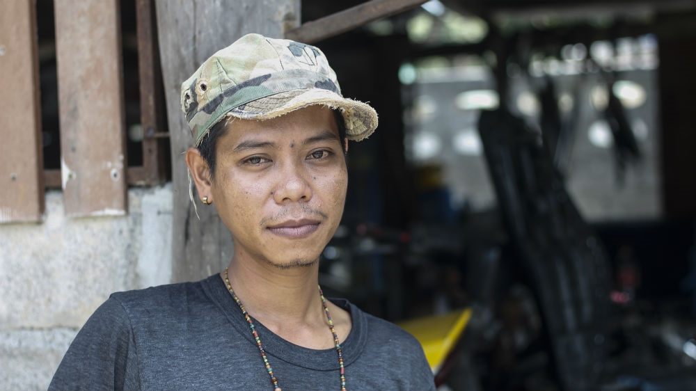 Ek, a 26-year-old motorcycle mechanic from Koh Samui, decided to sign up for the military because it meant a regular monthly wage. [Caleb Quinley/Al Jazeera] 
