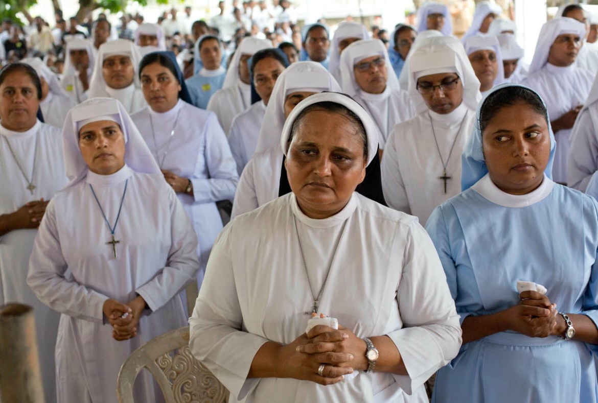 Catholic nuns attend a funeral service attended by Cardinal Malcolm Ranjith for Easter Sunday bomb blast victims at St. Sebastian Church in Negombo, Sri Lanka, Tuesday, April 23, 2019. (AP Photo/