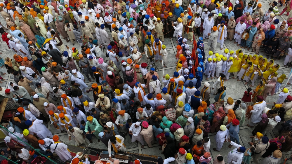 View of the crowd gathered for the Nagar Kirtan ritual of the Baisakhi festival [Asad Hashim/Al Jazeera] 