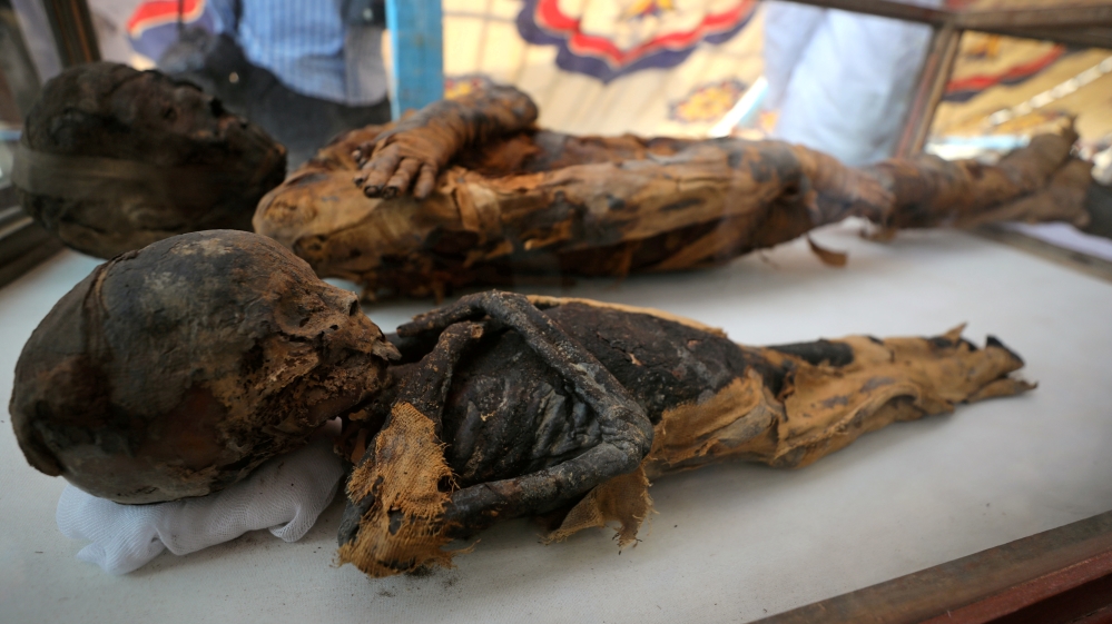 The mummies of a woman and a child were discovered at the burial site [Mohamed Abd el-Ghany/Reuters]