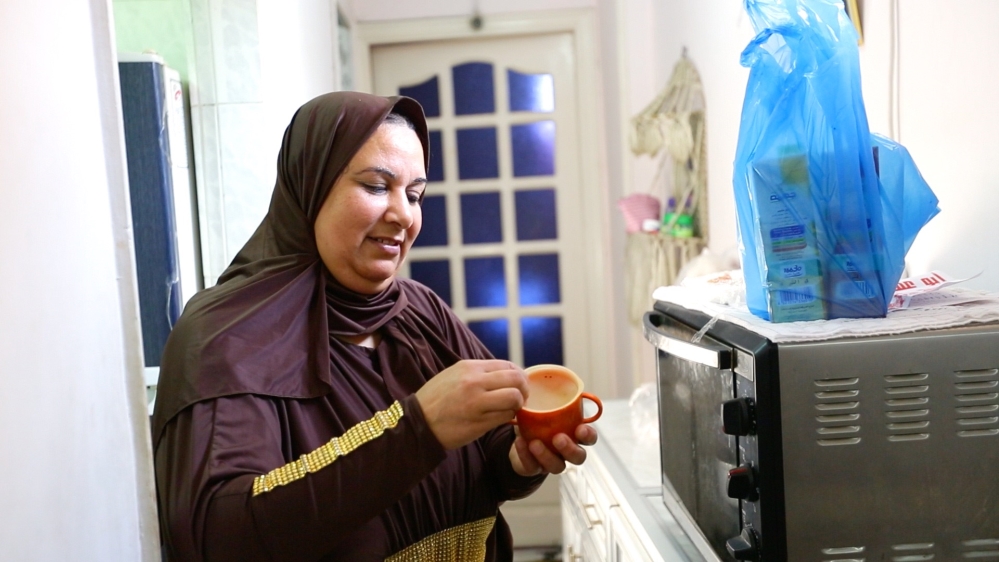 'I bought it for my first child, then I used it with my second child and the one after that,' says Afaf, holding a 25-year-old cup [Screengrab/Al Jazeera]