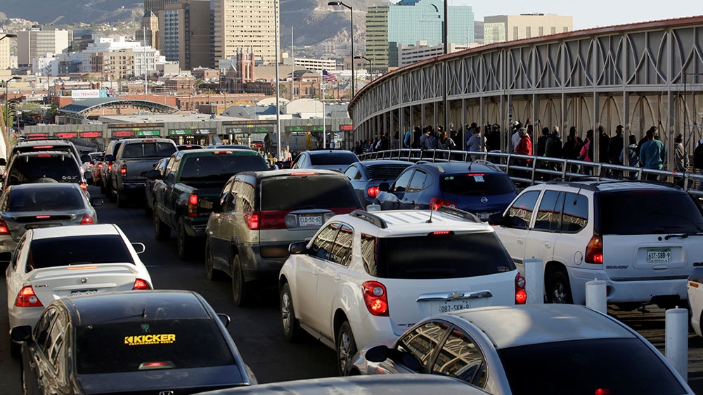 Drivers and commuters wait in line to cross to El Paso, Texas, on the international border crossing bridge Paso del Norte, in Ciudad Juarez, Mexico [Jose Luis Gonzalez/Reuters] 
