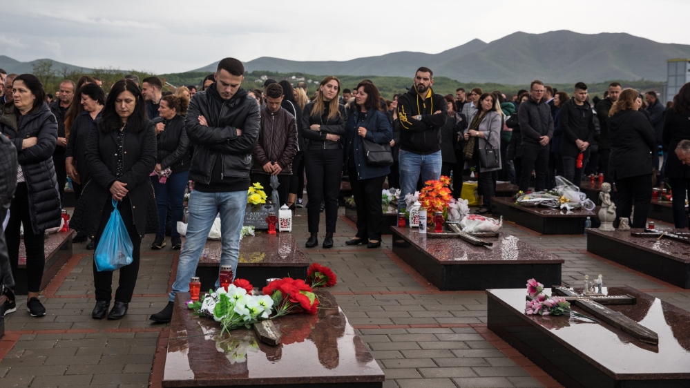 People visit the graves of loved ones at the Meja memorial complex in western Kosovo on the 20th anniversary of the massacre [Valerie Plesch/Al Jazeera]