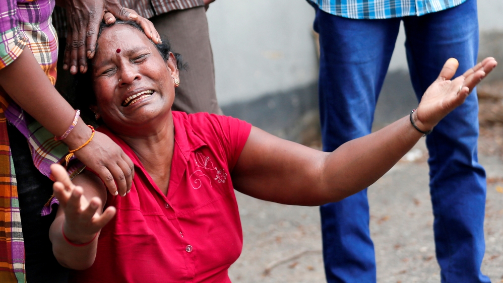 A relative of a victim of the explosion at St Anthony's Shrine mourns at the police mortuary in Colombo [Dinuka Liyanawatte/ Reuters]