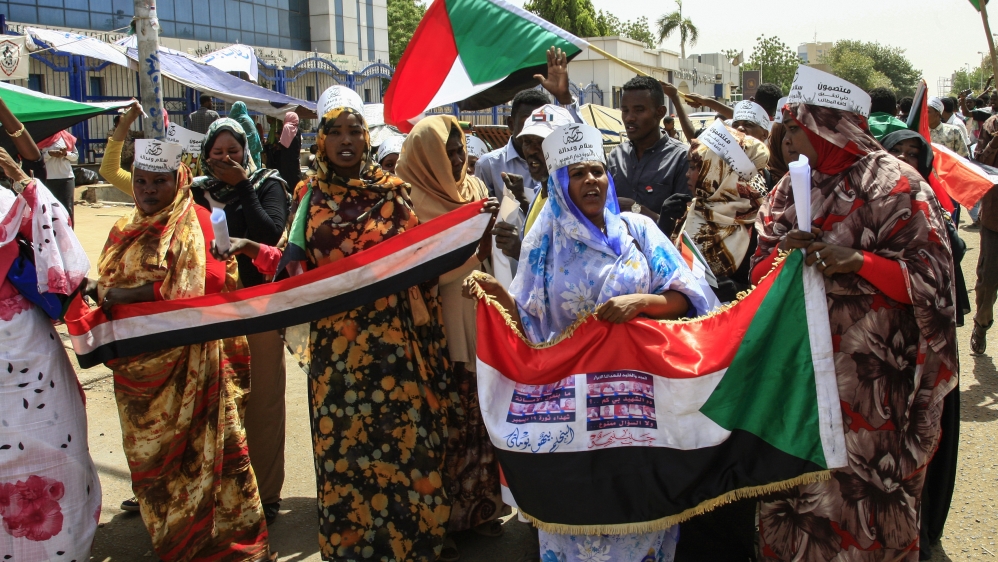 Sudanese protesters chant slogans during a rally outside the army headquarters in Khartoum [Ebrahim Hamid/AFP]