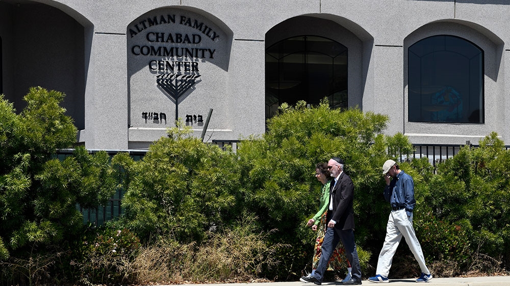 San Diego County Sheriff Bill Gore, left, walks past the Chabad of Poway Synagogue [Denis Poroy/AP Photo] 