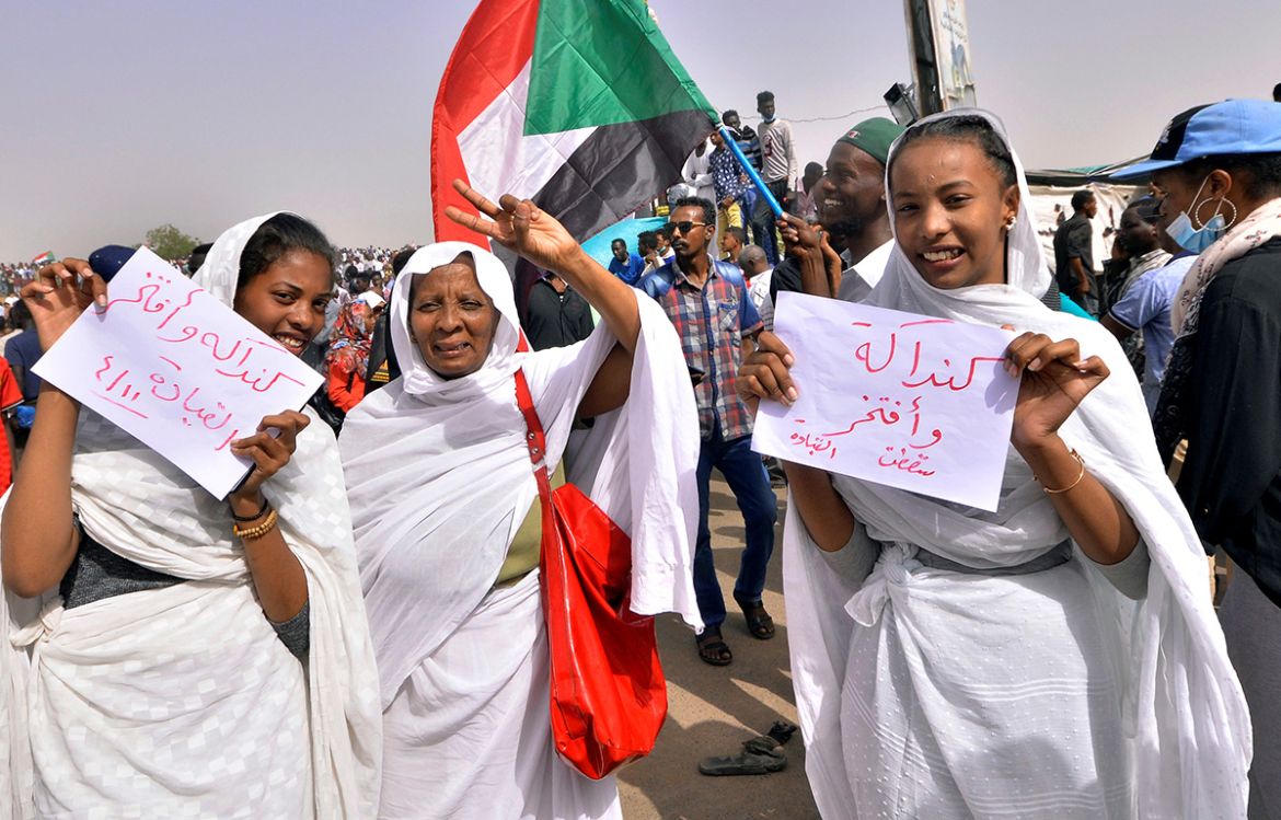Sudanese demonstrators chant slogans along the streets after Sudan''s Defense Minister Awad Mohamed Ahmed Ibn Auf said that President Omar al-Bashir had been detained "in a safe place" and that a mili