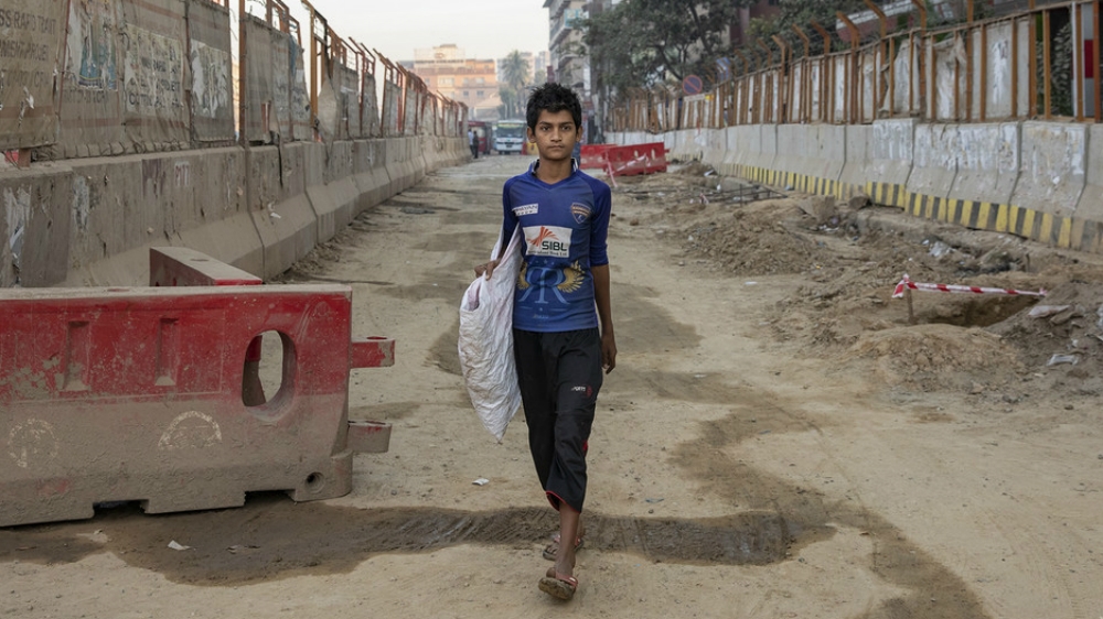 Mohamed supports his family by collecting plastic bottles for recycling, in Bangladesh [UNICEF]
