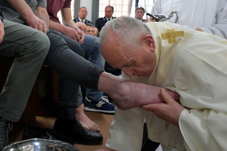 Pope Francis kiss a foot of an inmate during the celebrations of the Holy Thursday at the District House of Velletri prison, in Velletri near Rome