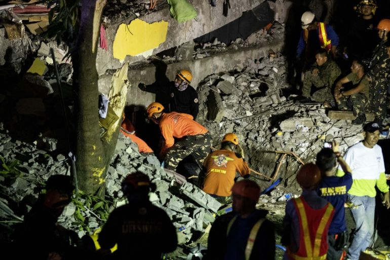 Rescue workers search through rubble in Porac, Pampanga, after a powerful earthquake hit northern Philippines on April 22, 2019. At least five people were killed when buildings collapsed near Manila a
