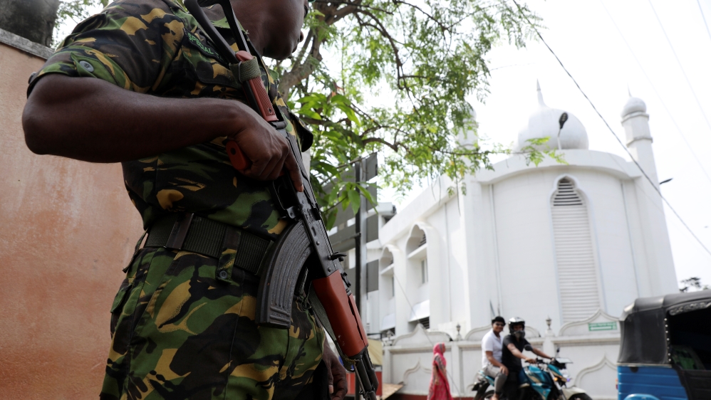 A soldier stands guard outside the Grand Mosque in Negombo, Sri Lanka [Reuters]