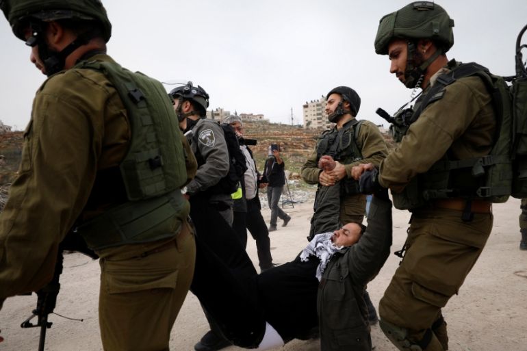 Israeli forces detain a Palestinian demonstrator during a protest demanding Israel to release Palestinian teenager Ahed Tamimi, near Israel''s Ofer Prison near the West Bank city of Ramallah