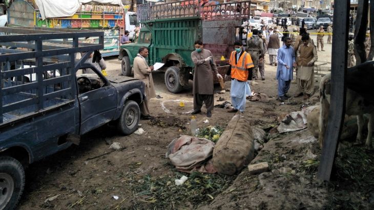 Members of the bomb disposal unit survey the site after a blast at vegetable market in Quetta,