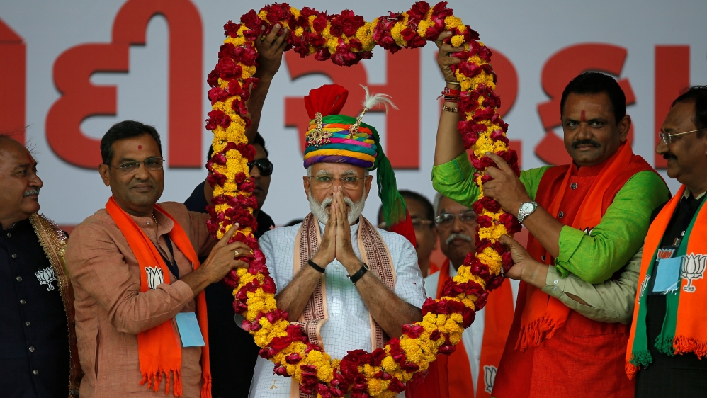 India's Prime Minister Narendra Modi gestures as he is presented with a garland during an election campaign rally in Himmatnagar, Gujarat, India, April 17, 2019 [Reuters/Amit Dave]